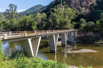 View of a dilapidated bridge with a river below

