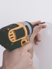 Person drilling in wall