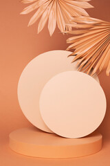 Fototapeta premium Luxury circle podium with palm leaves and frames on orange background. Concept scene stage showcase, for product, promotion, sale, banner, presentation, cosmetic. Minimal showcase mock up concept.