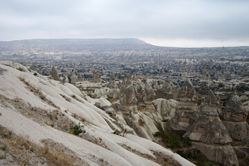 Natural landscape of Cappadocia, semi-arid region in central Turkey known for its distinctive fairy chimneys, tall cone-shaped rock formations clustered in Monks Valley, G&ouml;reme and elsewhere- Kayseri
