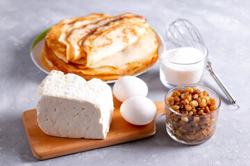 Products for cooking pancakes with cottage cheese. Eggs, cottage cheese, sugar and pancakes for cooking curd pancake.