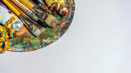 Artwork oil painting and accessories. White background, space for text.