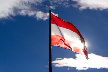 Waving flag of Austria backlit by the sun