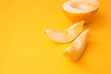 Fototapeta na wymiar Fresh sweet orange melon on yellow table. Summer fruit concept