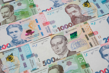 Background from the new banknotes of the Ukrainian hryvnia. Ukrainian money. A bill of one thousand hryvnia, five hundred and two hundred hryvnia and twenty hryvnia lying side by side.