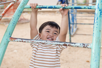 Asian little baby boy enjoy with outdoor zone kid park.
