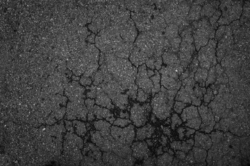 Crack background texture of rough asphalt top view