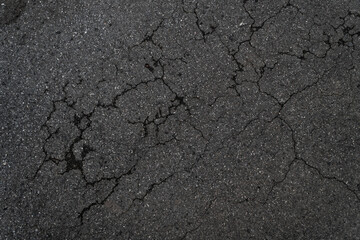 Crack background texture of rough asphalt top view