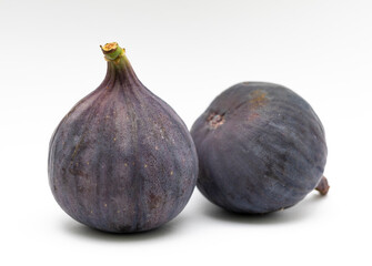Purple figs on a white background close-up.