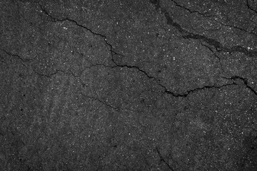 Fototapeta premium Crack background texture of rough asphalt top view