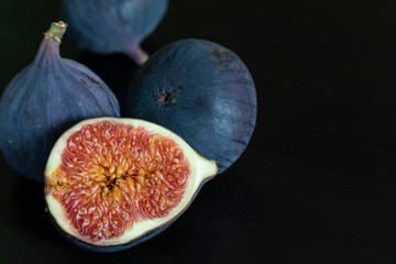 Ripe figs on a dark background close-up.