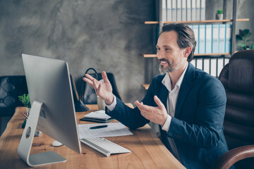 Profile side view portrait of his he nice handsome cheerful cheery man specialist attending web meeting discussing company development plan at modern concrete industrial work place station