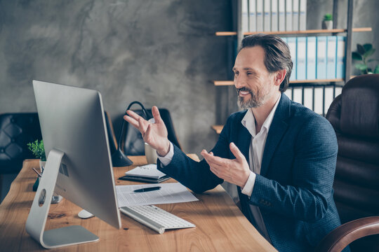 Profile side view portrait of his he nice handsome cheerful cheery man specialist attending web meeting discussing company development plan at modern concrete industrial work place station