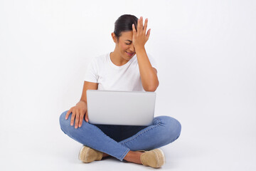 Frustrated brunette woman wearing casual clothes holding hand on forehead, frowning her face, being depressed having headache.