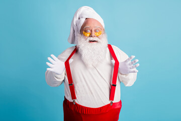 Fototapeta na wymiar Photo of retired old man grey beard play stripes excited anti age prevention procedure patch under eye wear santa x-mas costume towel turban suspender sunglass isolated blue color background