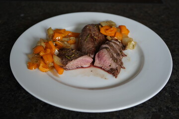 fresh cooking at home and ready to eat - roasted fillet from a red deer calf with onions and paprika