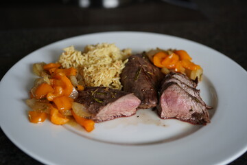 fresh cooking at home and ready to eat - roasted fillet from a red deer calf with onions and paprika