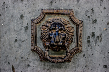 Retro door knocker mounted on a wooden door