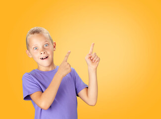 Funny surprised boy pointing with hand and finger