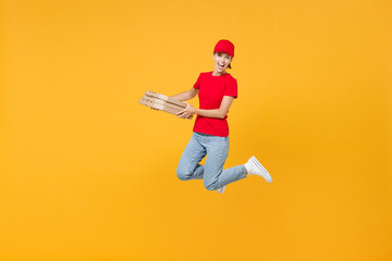 Fototapeta na wymiar Full length body fun delivery employee woman in red cap blank t-shirt uniform work courier in service jumping hold food order pizza in cardboard flatbox isolated on yellow background studio portrait.