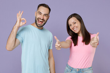 Smiling cheerful funny young couple two friends man woman 20s wearing blue pink empty blank design...