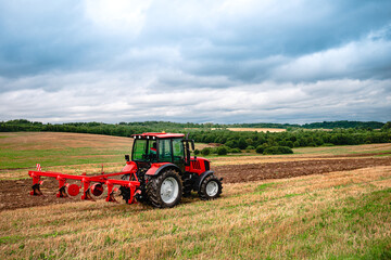 Agricultural tractor plowing the field