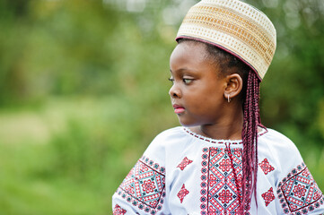 Portrait of african girl kid in traditional clothes at park.