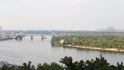 Top view of the old historical part of the city of Kiev. Vozdvizhenka area on Podol and the Dnieper river from the pedestrian bridge. Beautiful city landscape. 