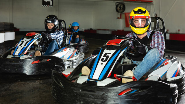 active people driving sport cars for karting in a circuit lap in sport club