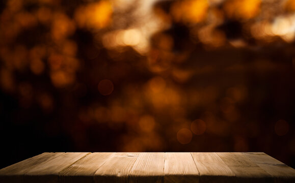 blurred background of bar and dark brown wooden desktop, place for a great product