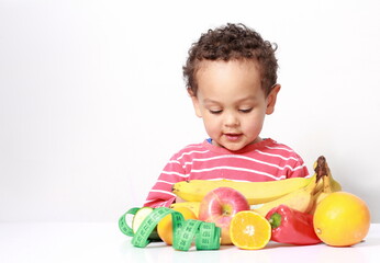 child with fresh fruits promoting healthy eating stock photo