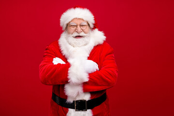 Photo of retired grandpa grey beard crossed arms certain look laughing funny occasion event wear x-mas costume leather belt gloves coat spectacles headwear isolated red color background