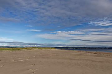 Fototapeta na wymiar The wide sandy deserted beach of Tentsmuir Point on the southern edge of the Tay Estuary, looking North towards Broughty Ferry,