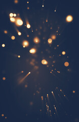 Festive abstract Christmas texture, golden bokeh particles and highlights on dark background....
