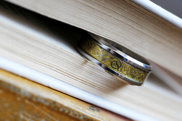 Golden ring and a book, macro