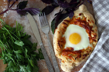 Khachapuri in Adjarian. Homemade khachapuri with egg. Georgian cuisine.
