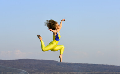 freedom is life. sport in motion. full of energy. Attractive young sporty woman is workout in outdoor gym. morning exercise. ukrainian national gymnast. Acrobatics and gymnastics. girl jumping high