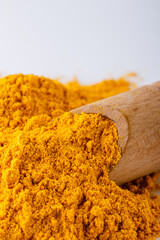natural turmeric powder on white acrylic background