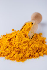 natural turmeric powder on white acrylic background