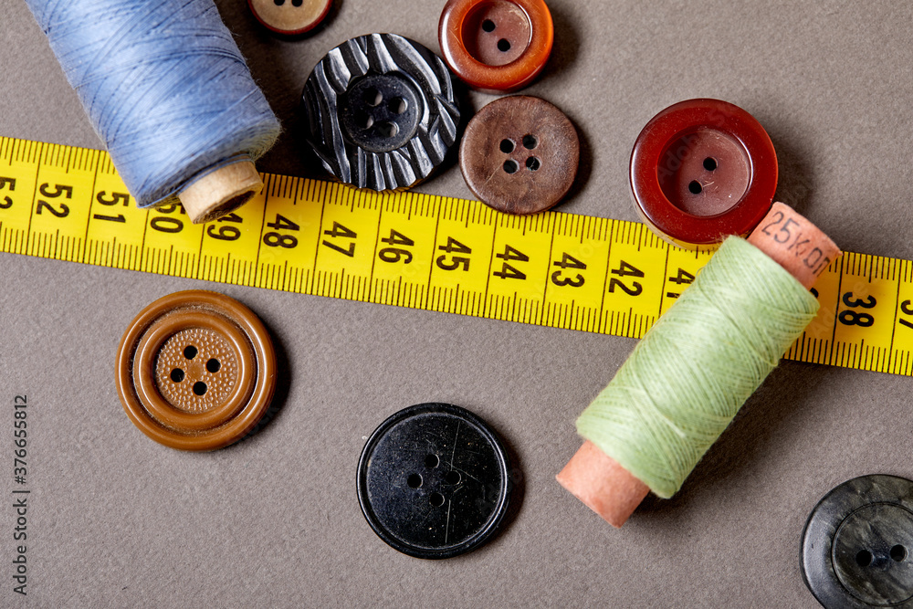 Poster background and texture of multicolored antique buttons and sewing tools