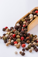 mix of peppercorns on white acrylic background