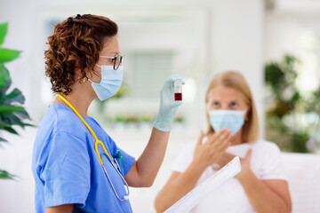Doctor examining sick patient. Ill woman in clinic
