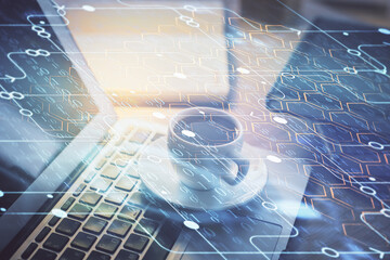 Double exposure of desktop computer and technology theme hologram. Concept of software development.
