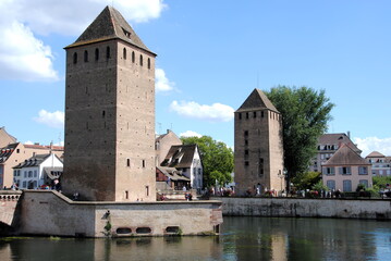 Fototapeta na wymiar View on the towers and bridges of the Ponts Couverts (Covered Bridges) that cross the four river channels of the River Ill flowing through Strasbourg's historic Petite France quarter. 