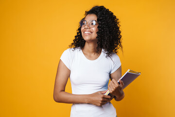 Image of african american woman in eyeglasses posing with exercise books