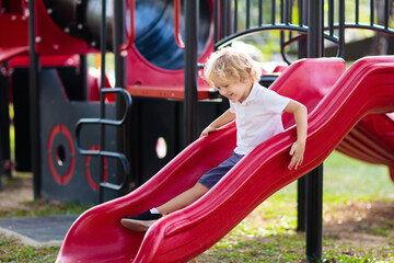 Child on playground. Kids play outdoor.