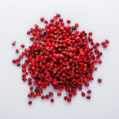 fragrant pink peppercorns on white acrylic background