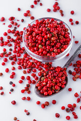 fragrant pink peppercorns on white acrylic background