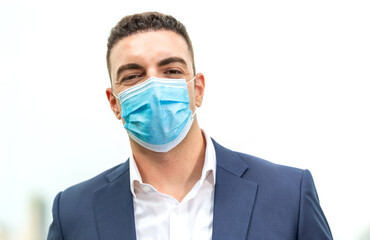 Portrait of Caucasian handsome business man wearing medical protective face mask to prevent...
