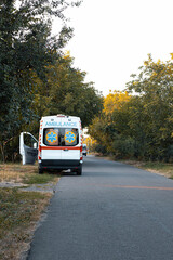 Naklejka na ściany i meble An ambulance car is parked on the side of the road. Home call